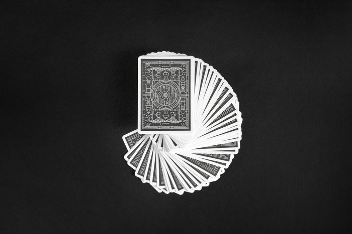 Fanned-out ornate deck of cards on a black background