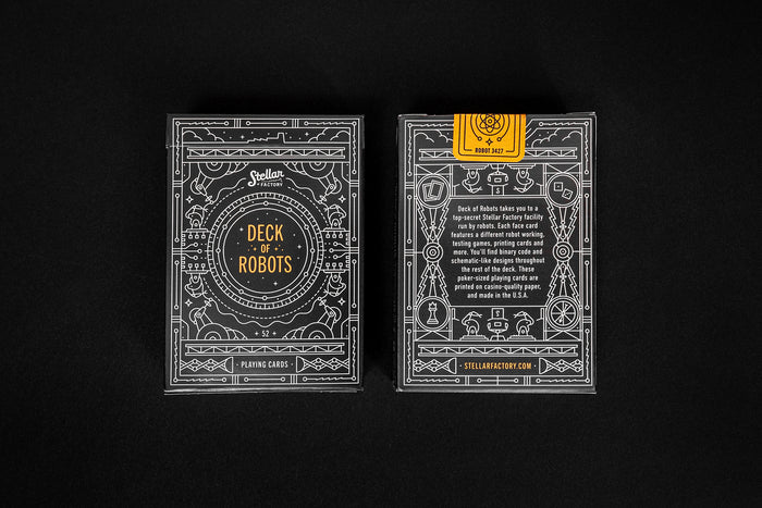 Two playing card decks with intricate black and white geometric space designs on a black background