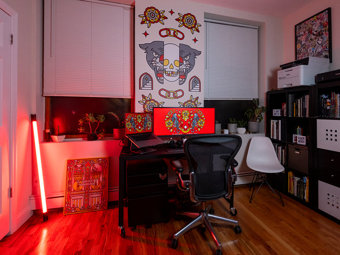 Home office with a desk, chair, and colorful wall art graphics by Red Halftone.
