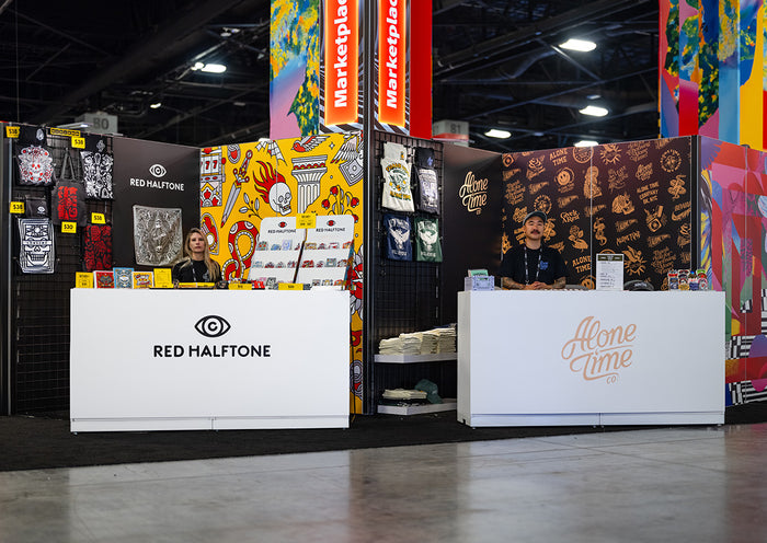 Two booths at Adobe MAX in Miami, FL with 'Red Halftone' and 'Alone Time' branding.