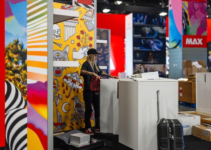Lisa Champ of Red Halftone setting up her display booth at Adobe MAX in Miami, FL.