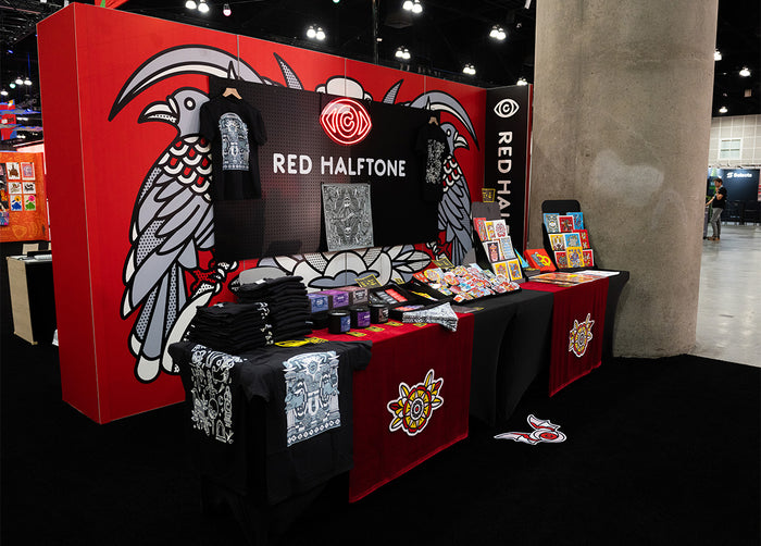 Red Halftone booth with merchandise display at Adobe MAX