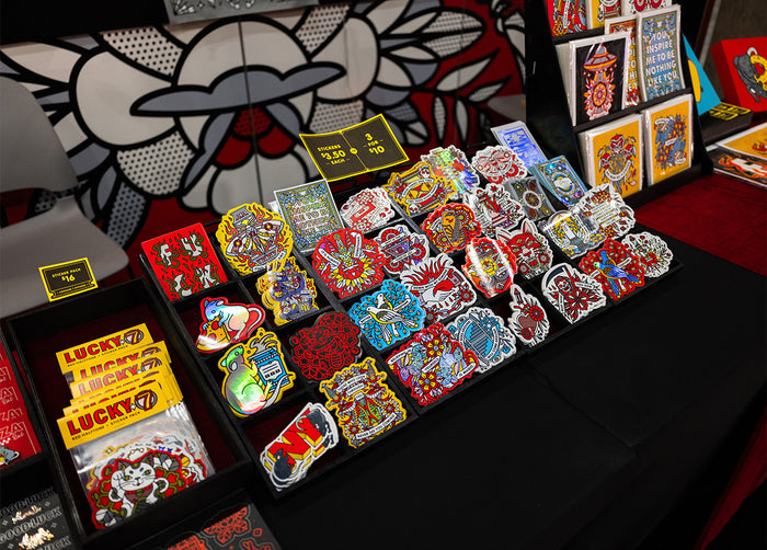 Collection of colorful Red Halftone stickers on a table with a decorative background