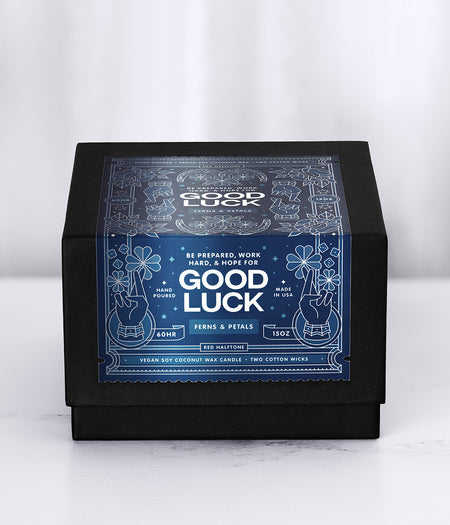 Good Luck candle packaging with a blue decorative label on a white background