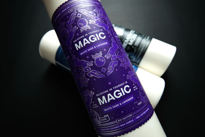 Purple "Magic" candle label on a roll on a dark background