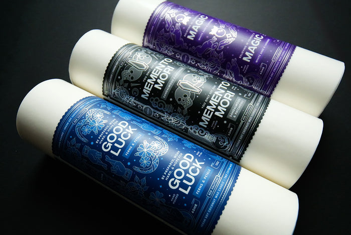 Three product labels on rolls on a black background
