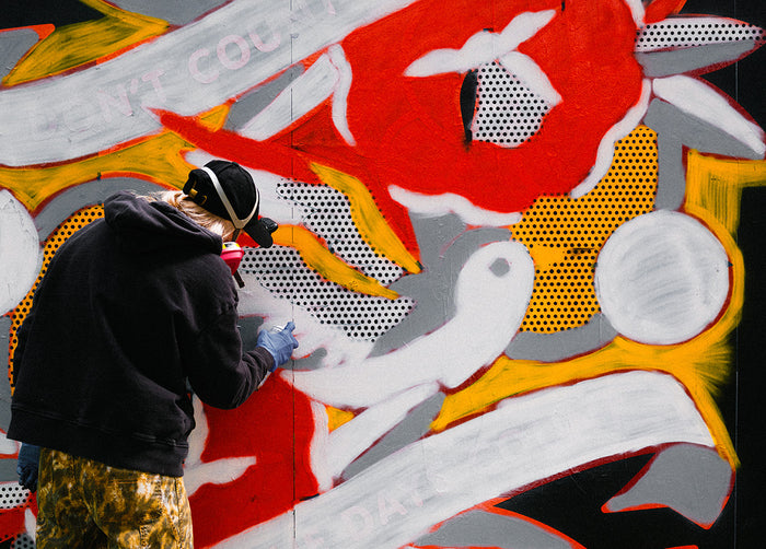 Artist Red Halftone painting a mural at East New York Walls