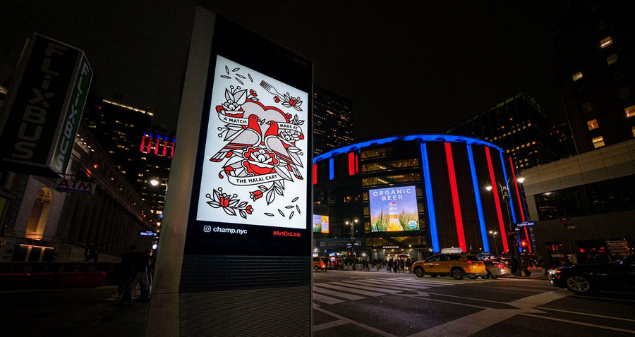 Digital kiosk in Midtown Manhattan featuring the artwork of the artist Red Halftone at night.
