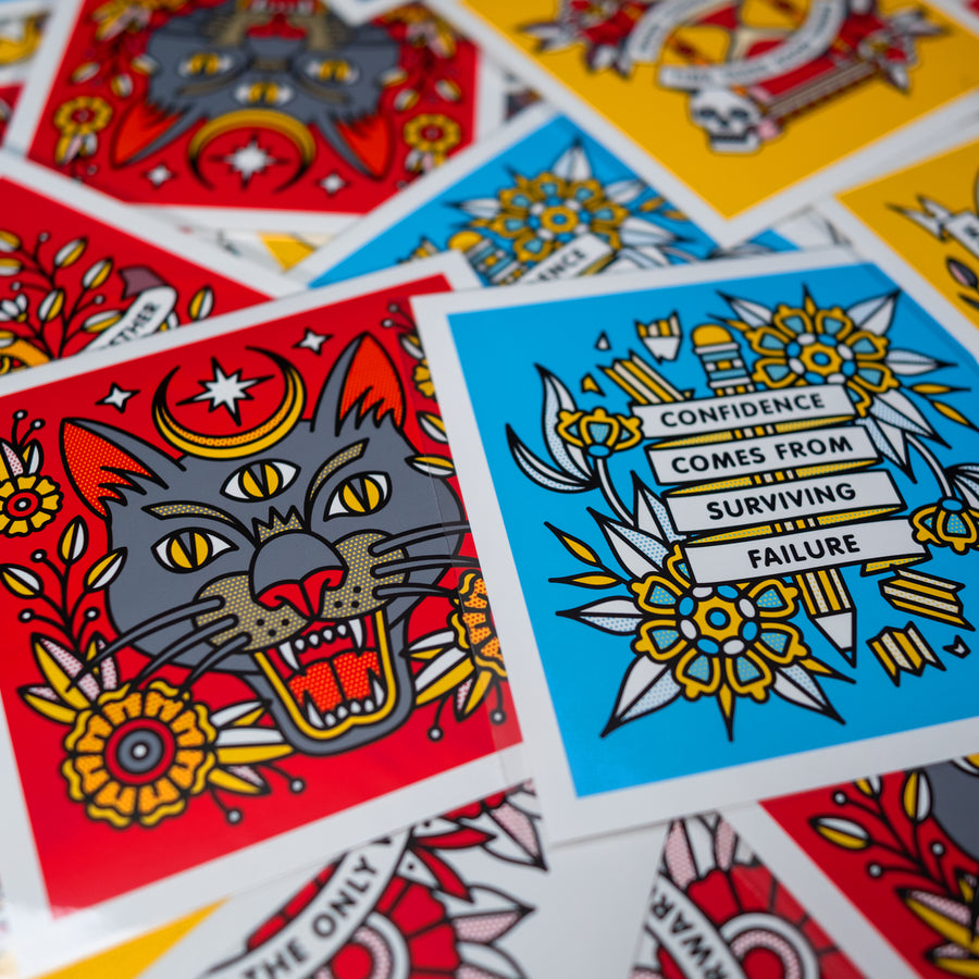 Many colorful mini prints by the artist Red Halftone scattered across a surface.