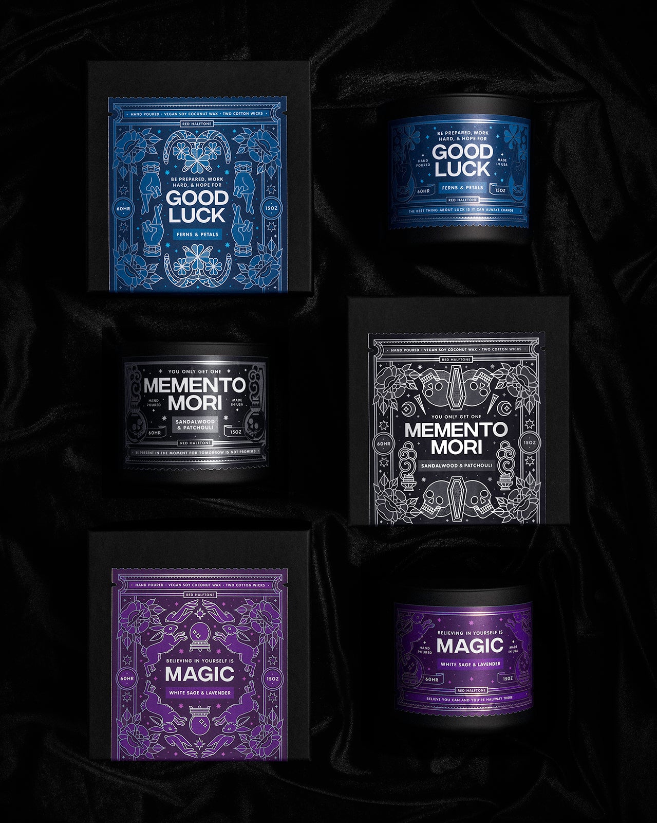 An overhead view of 3 candles with the boxes they come in arranged in a two by three grid on a dark velvet background.