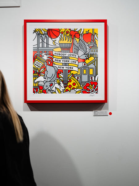 Framed artwork by Red Halftone with colorful design and text on a white wall, with a person partially visible on the left.