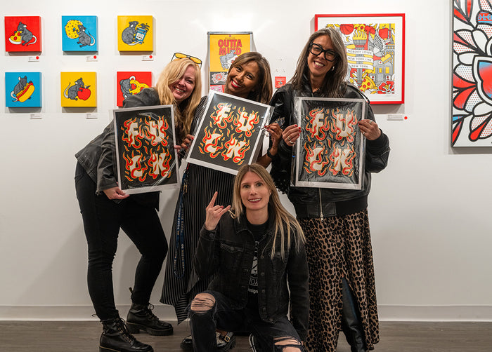 Four women holding limited editions prints by Red Halftone at Studio6 Gallery.