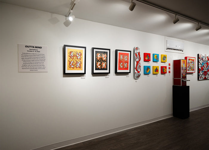 Various artworks by the Artist Red Halftone on the wall and a sign titled 'Outta Mind'.