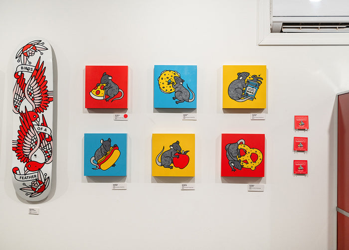 Collection of colorful paintings by Red Halftone featuring rats on a white wall.
