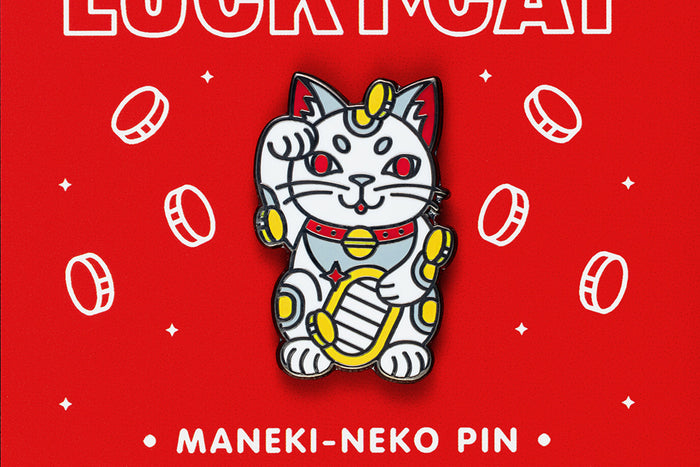 Maneki-neko enamel pin on a red background with coins and text