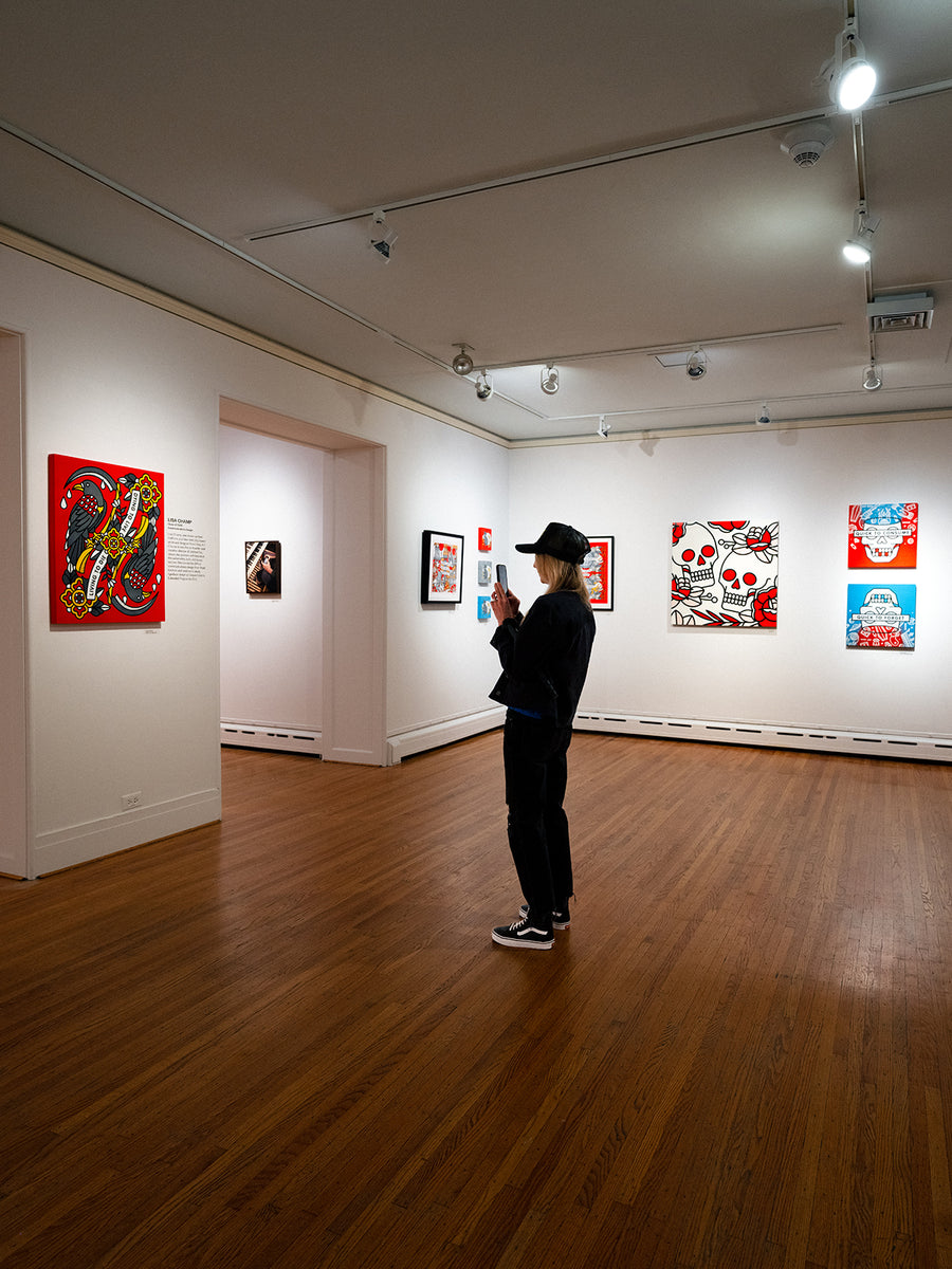 Lisa Champ of Red Halftone taking a photo of her artwork on display at Pratt Munson gallery