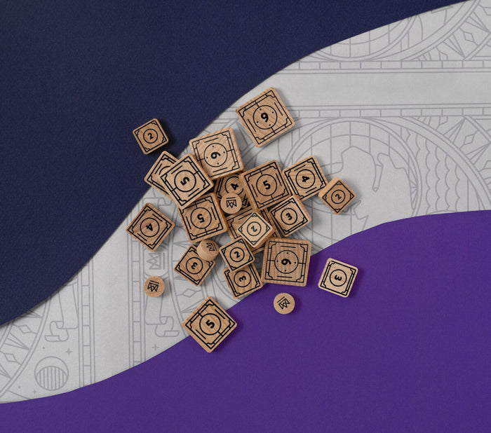 Square-shaped wooden game pieces with circular faces and numbers on a purple and gray patterned surface
