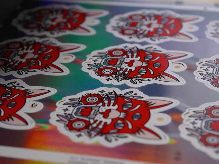 Hang tag stickers being printed on holographic material