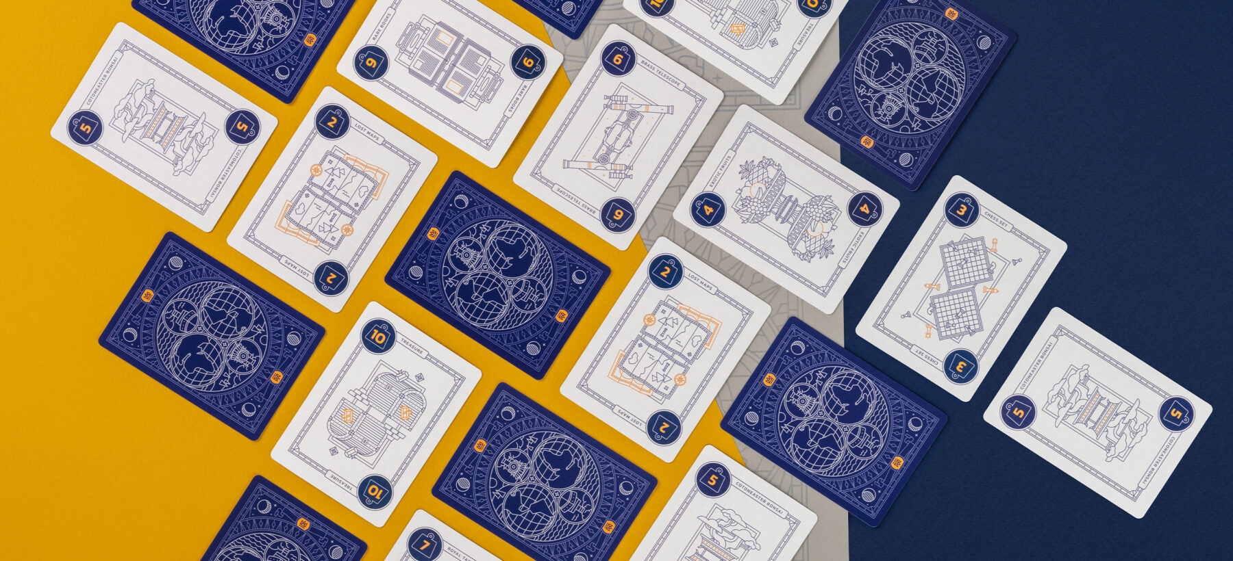 Front and backs of illustrated cards laid out in a grid on yellow and navy paper